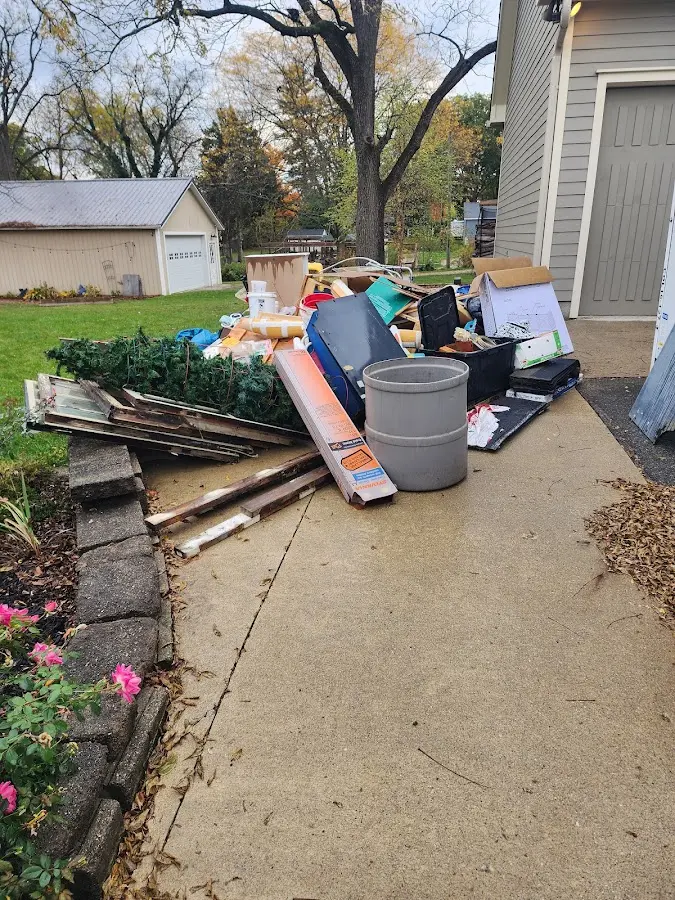 Dumpster being loaded with debris for Roofing Dumpster Rental in Hornell